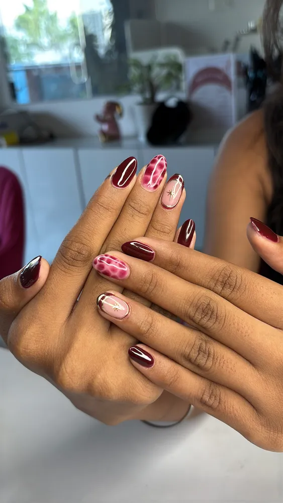 Hand-painted floral nail art at Ink & Claws, Handewadi